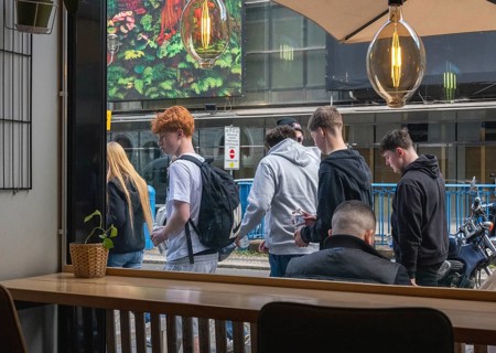 View through the window of a café of passers-by on Friedrichstraße in Mitte, Berlin, Germany