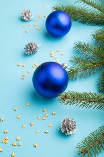 Christmas or New Year composition. Decorations, blue balls, cones, fir and spruce branches, on a