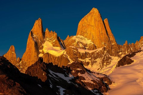 Mount Fitz Roy with secondary peaks in first sunlight, snow-covered rock flanks and granite peaks