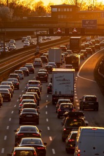 Motorway A40, dense, slow-moving traffic jam, evening traffic at the Essen-Kray junction, low sun,
