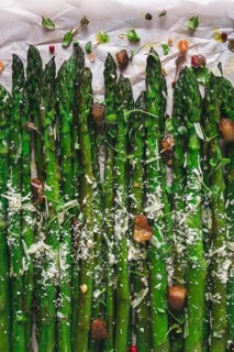Grilled asparagus, with spices and herbs, parmesan cheese, on a white background, top view, rustic,