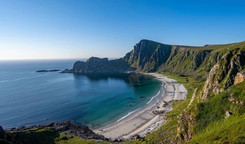 View of coastal landscape, cliffs with peak Måtind, Høyvika beach and sea, hike to the peak of