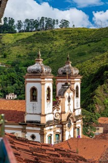Historic Baroque church tower rising from the rooftops of the city of Ouro Preto, Ouro Preto, Minas