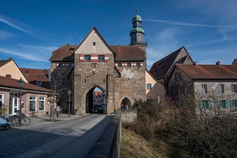 Historic Nuremberg Gate, built in 1526, tower of St. John's Church in the back, Lauf an der