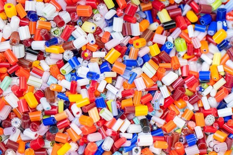 A vibrant assortment of Burano and Murano glass beads, showcasing a kaleidoscope of colors and