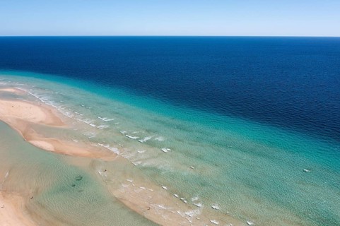 A stunning drone shot capturing the distinctive turquoise waters and sandy beach at Sotavento,