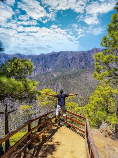 A young tourist at the Mirador Lomo de las Chozas de La Cumbrecita on the island of La Palma next