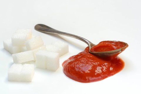 Ketchup in spoons and sugar cubes, sugar consumption