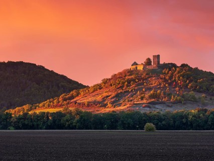 The ruins of Gleichen Castle on a hill in the last evening light, dramatic sunset, castle of the