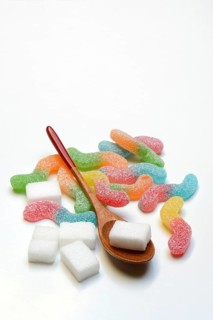 Lots of colorful jelly candies and sugar cubes, sugar consumption