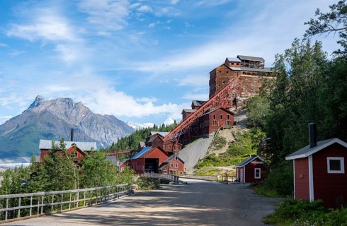 Red Kennicott buildings in front of mountainous landscape, Kennicott Concentration Mill to extract