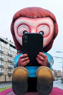 Young person staring at cell phone, social media addiction, social media ban, theme car by wagon