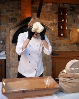 Greek woman baking Greek olive bread, Laconia, Peloponnese, Greece