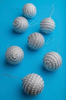 Christmas or New Year composition. Decorations, silver balls, on a blue paper background. Side