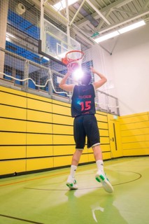 Players throwing a basketball in the sports hall, yellow wall, basketball TSV Calw, Germany