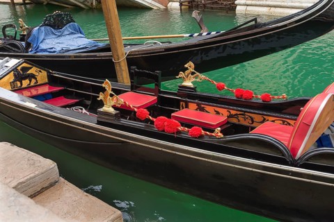 Decoratively furnished gondola with red seats, Venice, Veneto, Italy