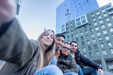 A caregiver and three young men with intellectual disabilities take a fun selfie in an urban