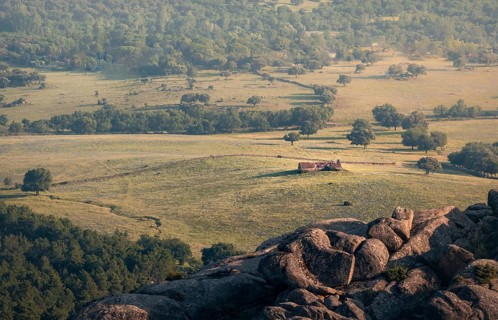 A breathtaking view from rocky ledge overlooking a verdant valley in the Guadarrama mountain range.