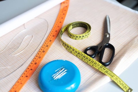 A vibrant collection of sewing essentials including scissors, measuring tape, and a ruler, all