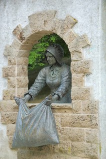 Monument to Brothers Grimm fairy tale Frau Holle, figure, cushion, window, shake, fairy tale