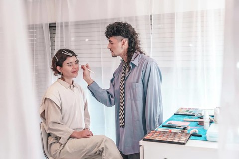 Skilled makeup artist carefully applies makeup to a client's face, enhancing their natural beauty