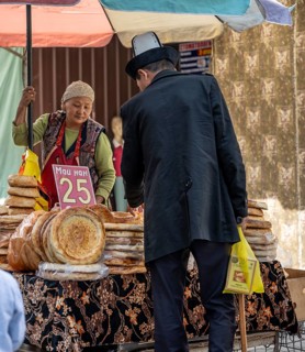 Woman selling bread at the Osh Bazaar, Bishkek, Kyrgyzstan