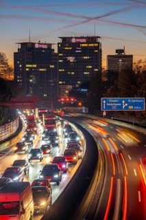 Evening traffic, partly with traffic jams, slow-moving traffic on the A40 motorway, Essen skyline,