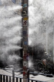 Cyclist through dense fog on an urban street, Vienna