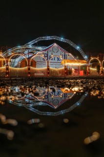Lights of the circus tent reflected in a puddle at night, Böblingen, Germany
