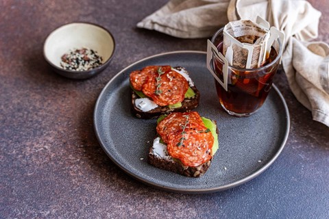 A delightful breakfast scene featuring slices of whole wheat bread topped with pepperoni and paired