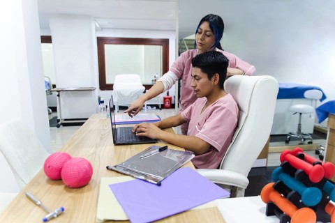 Professional physical therapists work as a team in a modern clinic in Ecuador. They focus on