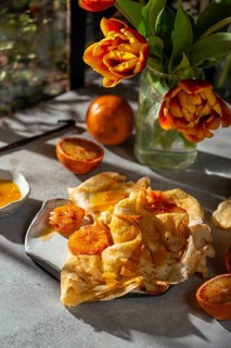 Light and airy crepes Suzette topped with a rich sauce made from caramelized sugar, butter, and