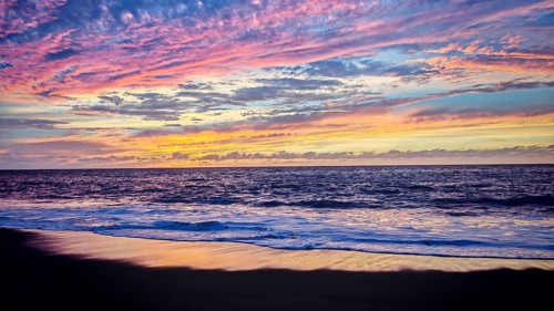 Purple-pink ocean cloudscape at sunset with soft waves, romantic, Tarrafal de Monte Trigo, Santo