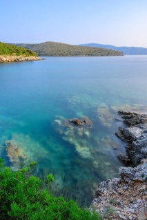 Crystal clear and turquoise water on the beach of Ustrine Bay on a sunny day at sunset on the