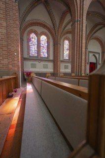Close-up of church pews with light reflections from colorful windows, Sacred Heart, Bregenz,