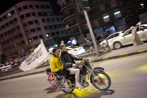 Damascus, Syria. December 7th 2025. Syrians on a motorcycle with an Islamic flag ride in