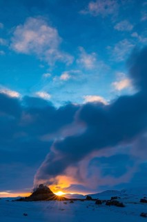 Mud pot with steam source at sunrise, Hverir solfataras field, fumaroles, snow-covered geothermal