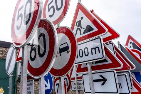 Storage for traffic signs in the yard of a road maintenance department, various signs with