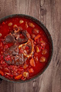 Ossobuco stew with vegetables, knuckle on the bone with new potatoes, in tomato sauce, homemade,