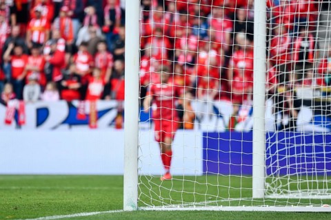 Soccer goal post and soccer match in the background in Lodz, Poland