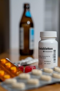 Symbolic image of alcohol and medication, you should not take medicine, pills, tablets with