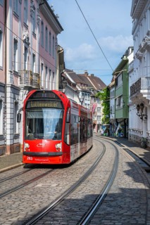 A tram travelling through the historic old town of Freiburg im Breisgau, Baden-Württemberg, Germany