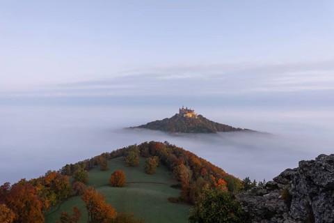 Hohenzollern Castle in a sea of fog at sunrise, autumn in the Swabian Jura
