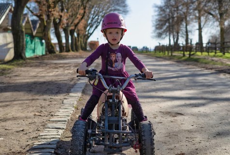 Girl, 4 years, blonde, crash helmet, riding quad, children's quad bike, Sonnenhof,