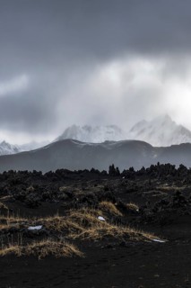 Captivating view of the Icelandic Highlands featuring rugged volcanic terrain, dark rocks, and