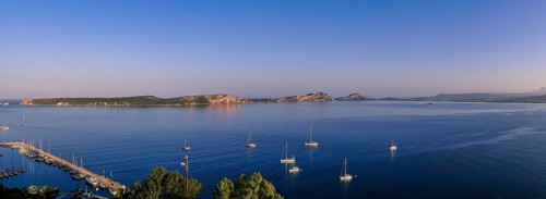 Several sailboats float on a wide, calm lake in soft morning light, Navarino Bay, Pylos,
