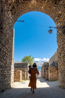 Mother with her son walking through the Ottoman castle fortress of Gjirokaster or Gjirokastra.