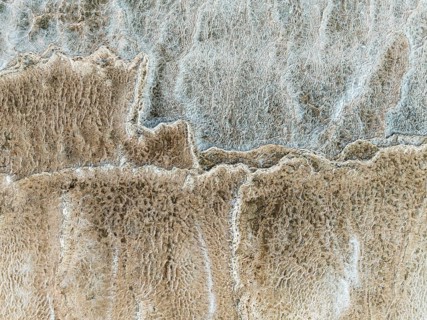 Abstract patterns of saline deposits at the salt works of Walvis Bay. Aerial view. Drone shot.