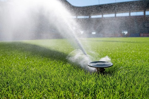 Watering grass on a football stadium in Lubin, Poland