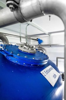 Detail of a blue tank with silver pipework and labelling, ENCW Netze Calw waterworks, Calw, Black